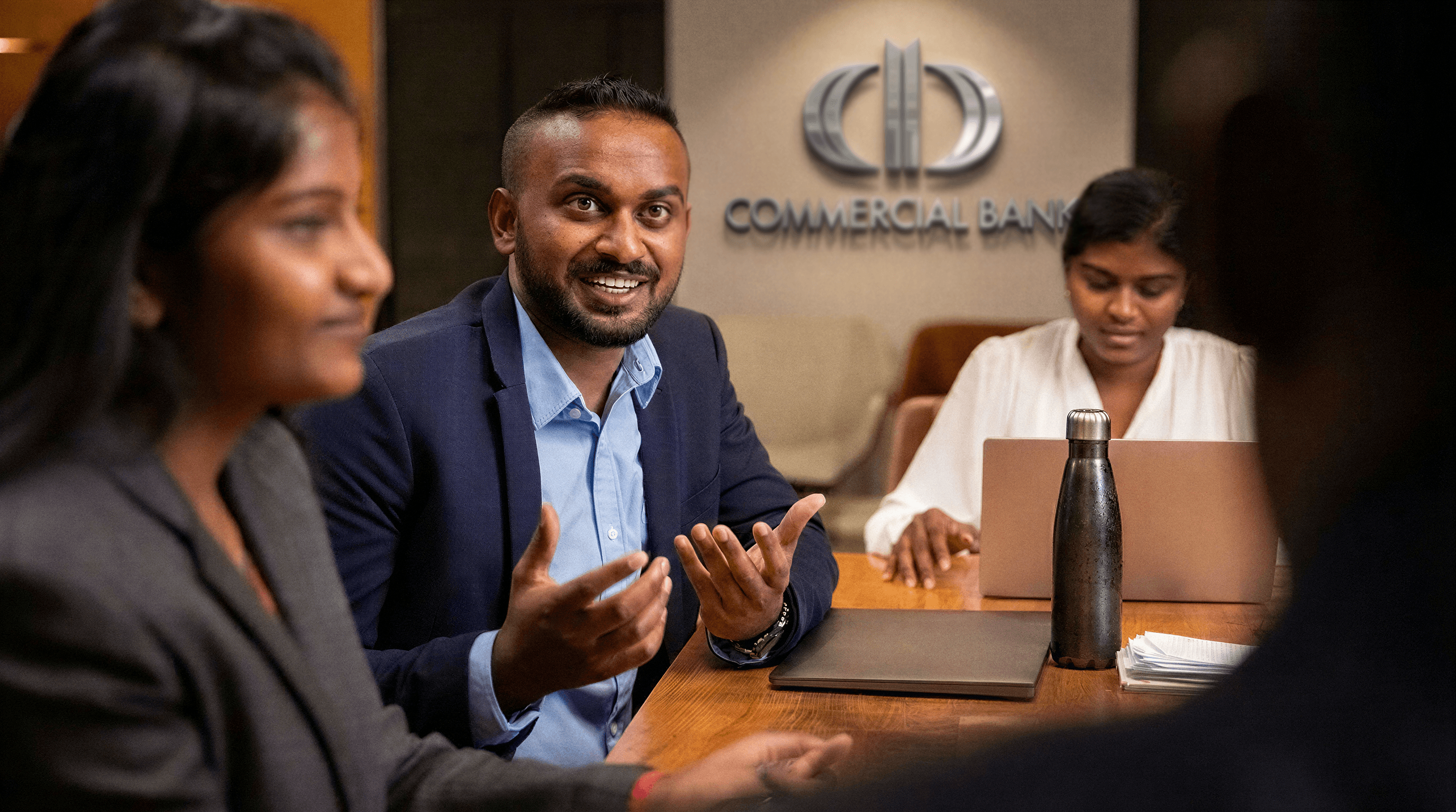 Commercial Bank team members in discussion around a meeting-room table